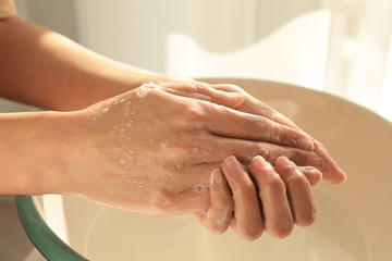 Woman washing hands at home