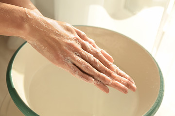 Woman washing hands at home