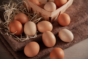 Raw chicken eggs scattered on the table.