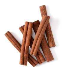 Cinnamon sticks isolated on white background closeup. Canella spice. Aromatic condiment background. Flat lay, top view.