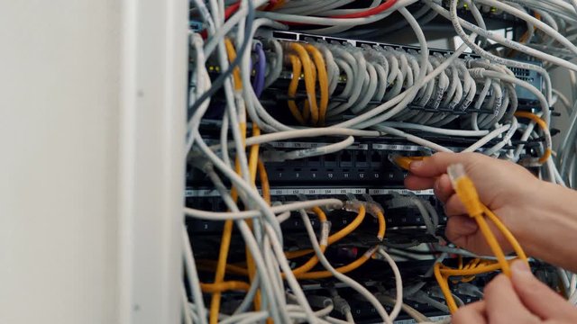 Server IT Engineer In Data Center Server Room.Network Engineer Working Laptop Computer.Server Rack Room Works.Programmer Checks A work Of Server At A Data Center. 