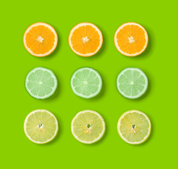 Citrus Fruits pattern on green background. Orange, Lime, Lemon slices background. Flat lay, top view. .  Pop art design, creative summer concept.. Creative layout.