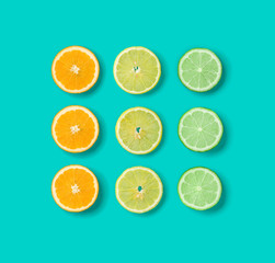 Citrus Fruit pattern on blue background. Orange, Lime, Lemon slices background. Flat lay, top view. .  Pop art design, creative summer concept.. Creative layout.