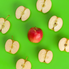 Fruit pattern of apple halves on green background. Flat lay, top view. Food background. .  Pop art design, creative summer concept.. Creative layout.