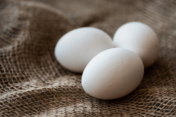Chicken eggs on burlap.