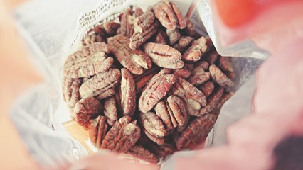 Expired food in plastic container, Close up of fungus on expire organic pecan nuts, unhealthy for your health, can't to eat. toxic food. 