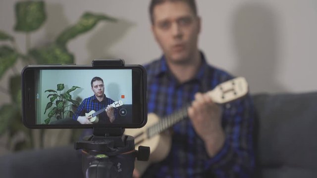 Handsome man recording song. Vlogging concept.