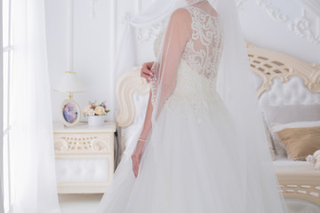 Fototapeta na wymiar bride in a wedding dress in a bright room