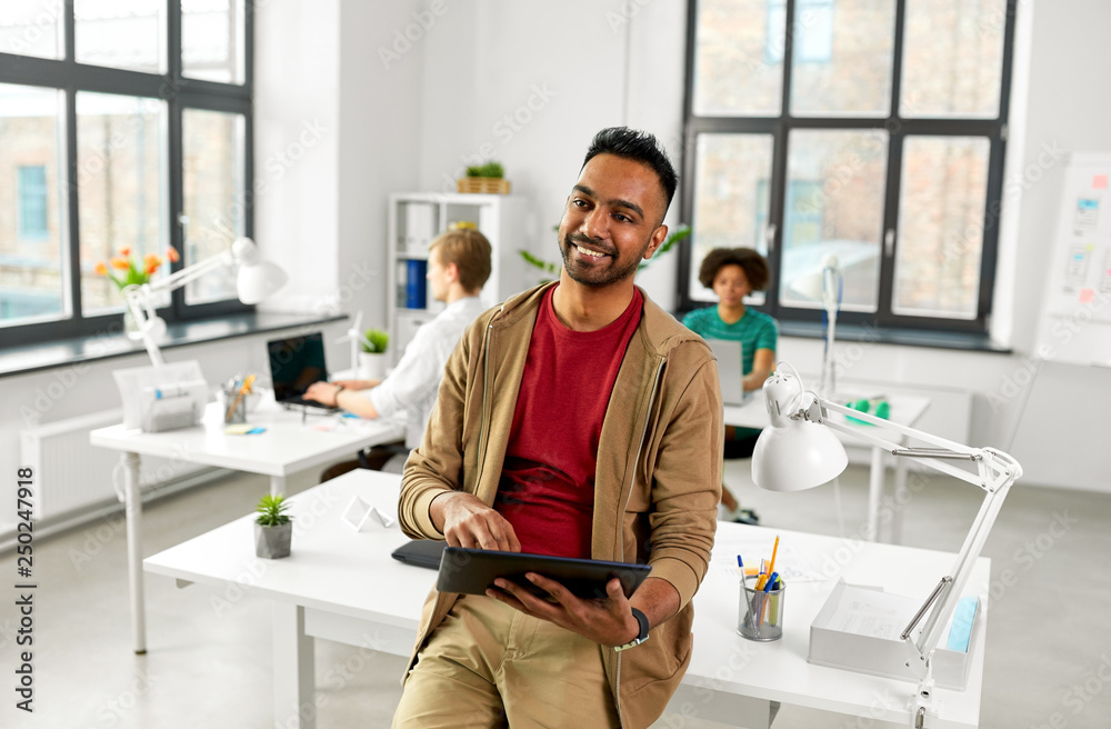 Poster business, technology and people concept - happy smiling indian man with tablet pc computer at office