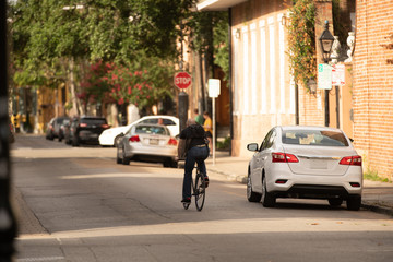 unknown man rides his bike to work to save gas and money