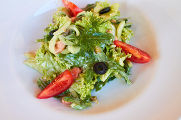 vegetable salad with tomatoes, shrimps and olives. diet food. lean food for believers