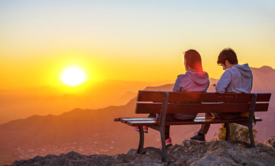 Fototapeta na wymiar Couple sitting together watching the sunset
