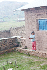 Fototapeta premium Native american little girl catching drops of the rain. Rural landscape.