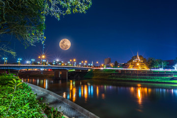 Super Full Moon over Pagoda on the Temple That is a tourist attraction, Phitsanulok, Thailand. February 2019 at night