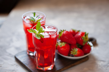 Fresh strawberry lemonade garnished with mint, copy space