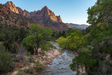 The incredible Zion National Park, sweeping panorama with mountains in the distance and a stream in the foreground