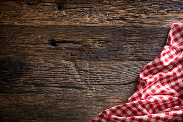 Red checkered kitchen tablecloth on rustic wooden table