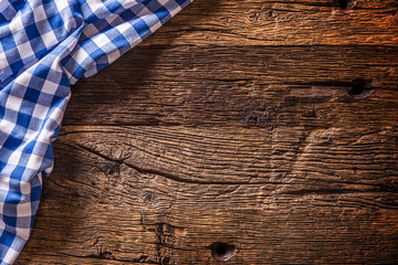 Blue checkered kitchen tablecloth on rustic wooden table