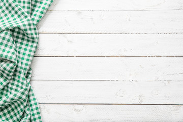 Green checkered kitchen tablecloth on wooden table