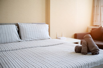 Clean stack of towels in hotel bedroom.
