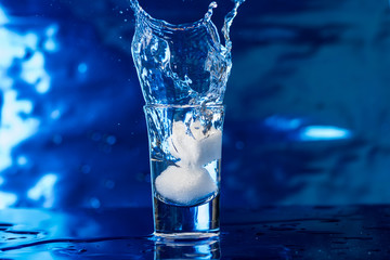 a piece of sugar is thrown into a small glass of water