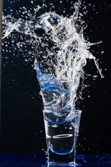 Two small glasses are beating each other on the fragments