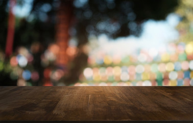 Empty dark wooden table in front of abstract blurred bokeh background of restaurant . can be used for display or montage your products.Mock up for space.
