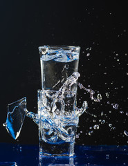 Two small glasses are beating each other on the fragments