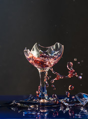 Two small glasses of wine are beaten each other on the shards