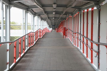 footbridge, pedestrian overpass, or pedestrian overcrossing that made of metallic triangular structure, that connects railway railroad train station