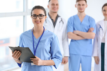 Fototapeta premium Female doctor and her colleagues in clinic