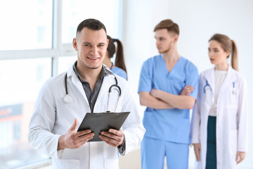 Male doctor and his colleagues in clinic