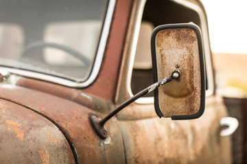 Close up of a rusty mirror on a truck