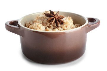 Pot with tasty oatmeal on white background