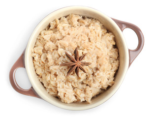 Pot with tasty oatmeal on white background