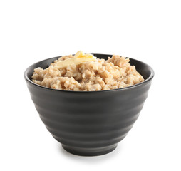 Bowl with tasty oatmeal on white background