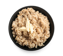 Bowl with tasty oatmeal on white background