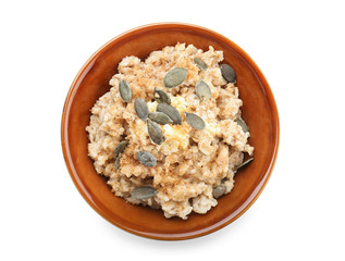Bowl with tasty oatmeal on white background