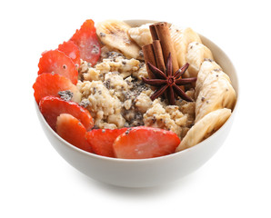 Bowl with tasty oatmeal on white background