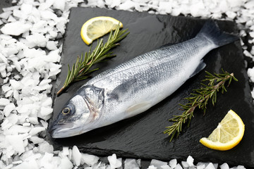 Tasty fresh seabass fish on slate plate
