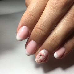 Flesh-colored manicure on nails. Female manicure