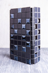 A black tile with glossy inserts