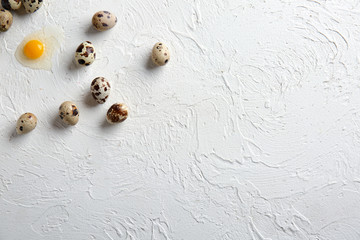 Fototapeta na wymiar Fresh raw quail eggs on white table