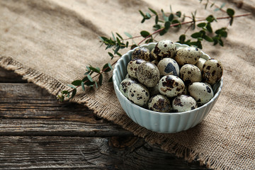 Bowl with quail eggs on table