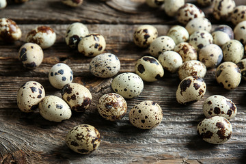 Many quail eggs on wooden table