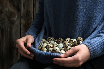 Woman with fresh quail eggs, closeup