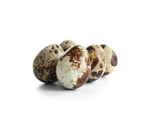 Raw quail eggs on white background