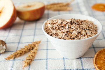 Bowl with raw oatmeal on table