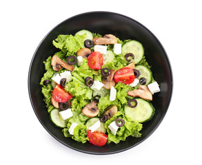 Plate with tasty fresh salad on white background