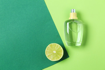 Bottle of citrus perfume on color background - obrazy, fototapety, plakaty
